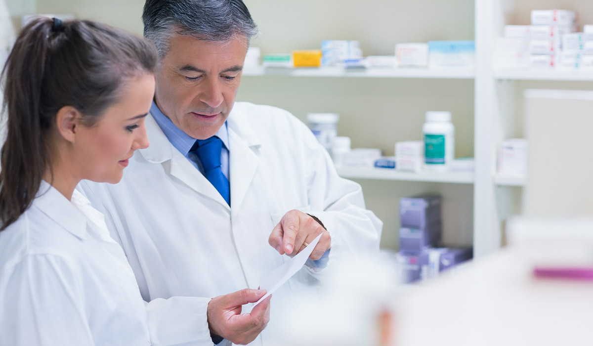 Pharmacist explaining a prescription to his trainee