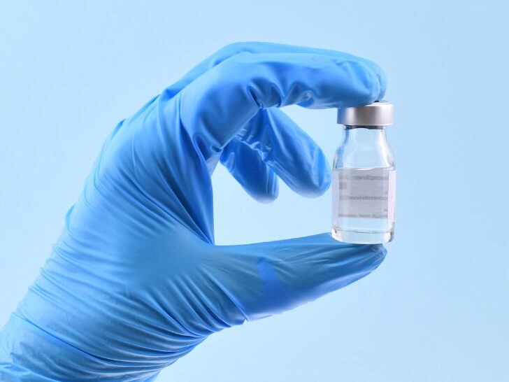 healthcare professional holding treatment vial